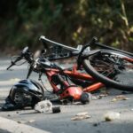 broken-bicycle-on-the-road-accident-in-the-road-bicycle-crash-road-accident-with-broken-bike-and-helmet-ai-generated-free-photo