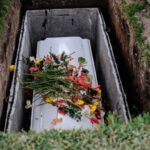 casket-of-the-dead-with-flowers-from-family-and-acquittances-on-the-cover-laid-to-final-rest