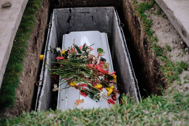 casket-of-the-dead-with-flowers-from-family-and-acquittances-on-the-cover-laid-to-final-rest